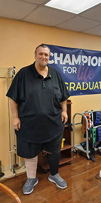 Patient Charles Butcher celebrating improved mobility at Henry Ford Health Brownstown.