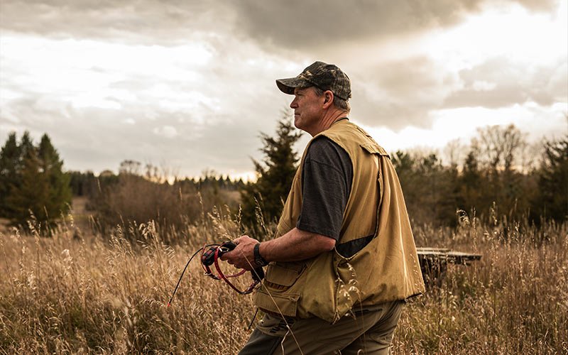 Cancer Patient Jeffrey Clark walking through the field