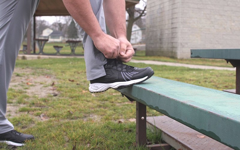 Patient lacing up comfortably after foot nerve resection surgery