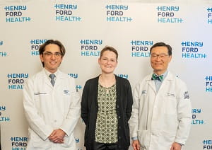 Combined Intestinal-Kidney Transplant recipient standing with transplant physicians 