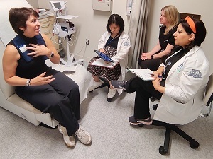 Adaptive deep brain stimulation patient meets with providers