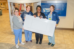 Henry Ford Health staff holding UV Angel Air unit